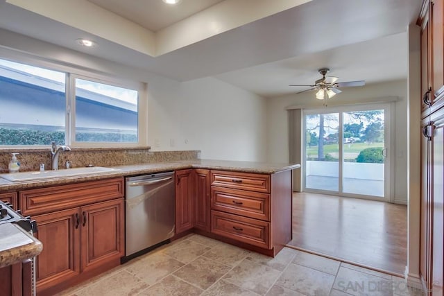 kitchen featuring dishwasher, kitchen peninsula, a healthy amount of sunlight, and sink