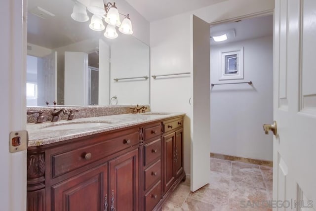 bathroom featuring vanity and a chandelier