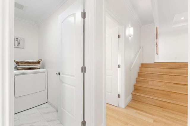 laundry room featuring washer / dryer and ornamental molding