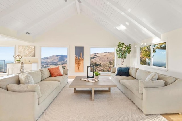 living room with beam ceiling, a mountain view, and high vaulted ceiling