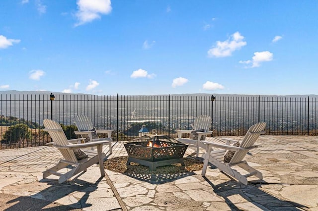 view of patio / terrace with a water view and a fire pit