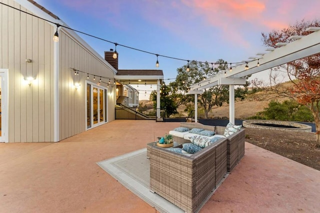 patio terrace at dusk featuring an outdoor hangout area