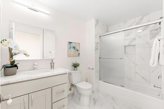 full bathroom with toilet, bath / shower combo with glass door, and vanity