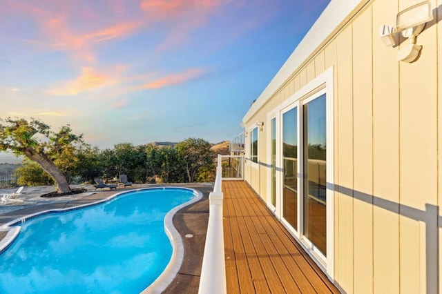 view of pool at dusk