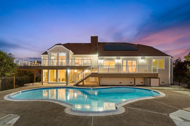 pool at dusk featuring a patio area