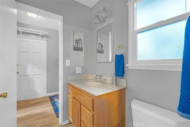 13621 Arcturus Ave, Gardena, CA 90249 - bathroom with vanity, healthy amount of natural light, and wood finished floors