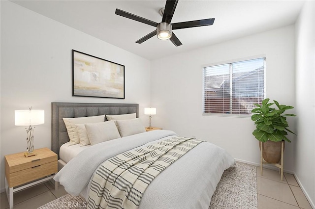 bedroom with ceiling fan and light tile patterned floors