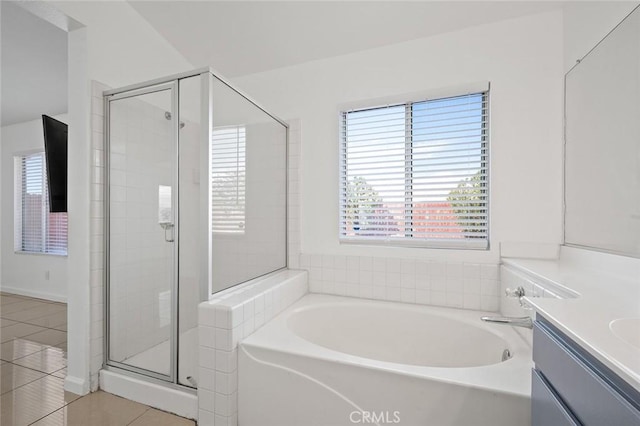 bathroom with tile patterned flooring, vanity, and plus walk in shower