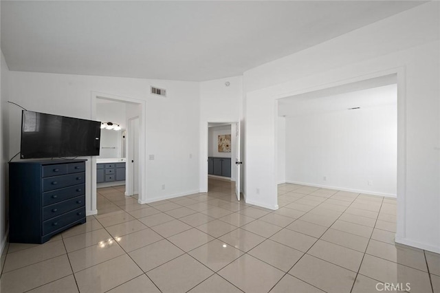 unfurnished living room with lofted ceiling and light tile patterned floors