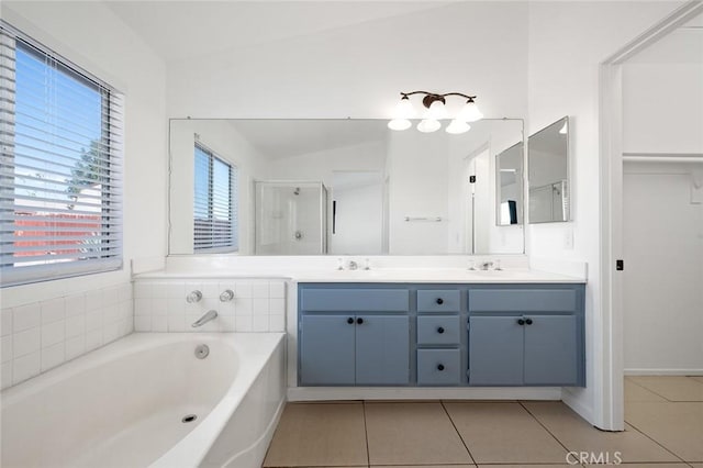 bathroom featuring tile patterned flooring, vanity, vaulted ceiling, and plus walk in shower