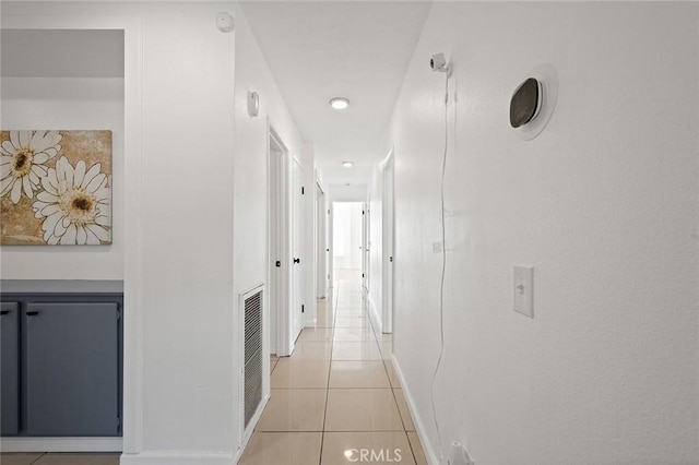 hall featuring light tile patterned floors