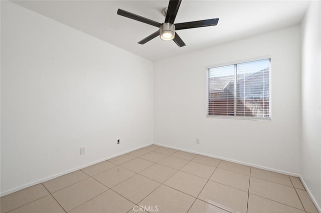 spare room featuring light tile patterned floors and ceiling fan