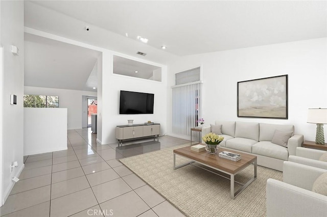 tiled living room featuring high vaulted ceiling