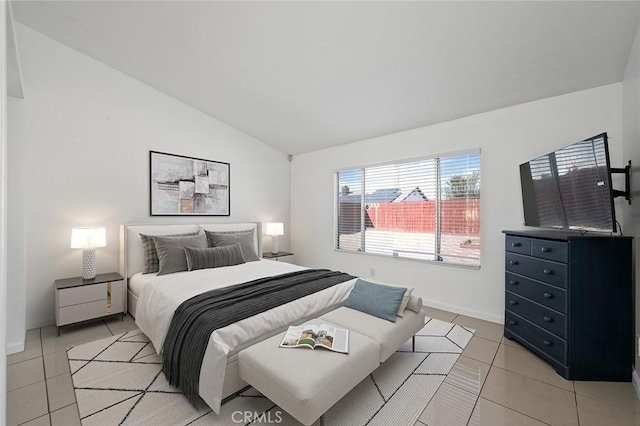 bedroom featuring lofted ceiling and light tile patterned flooring