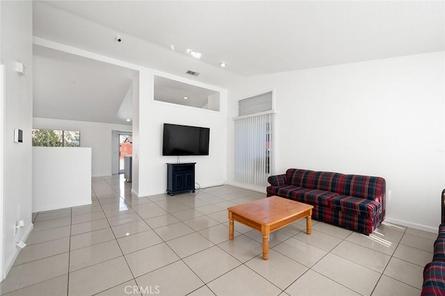 tiled living room featuring high vaulted ceiling