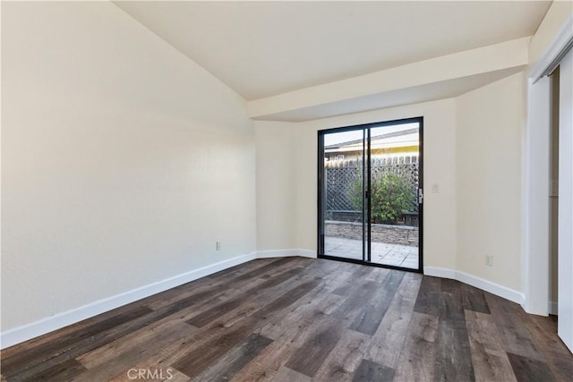 unfurnished room featuring vaulted ceiling and dark hardwood / wood-style floors