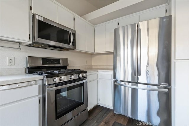 kitchen featuring white cabinetry, appliances with stainless steel finishes, and dark hardwood / wood-style flooring