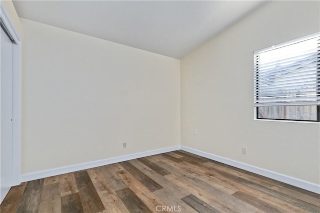 spare room with hardwood / wood-style flooring