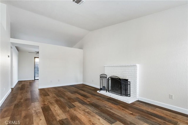 unfurnished living room featuring ceiling fan, dark hardwood / wood-style flooring, lofted ceiling, and a fireplace