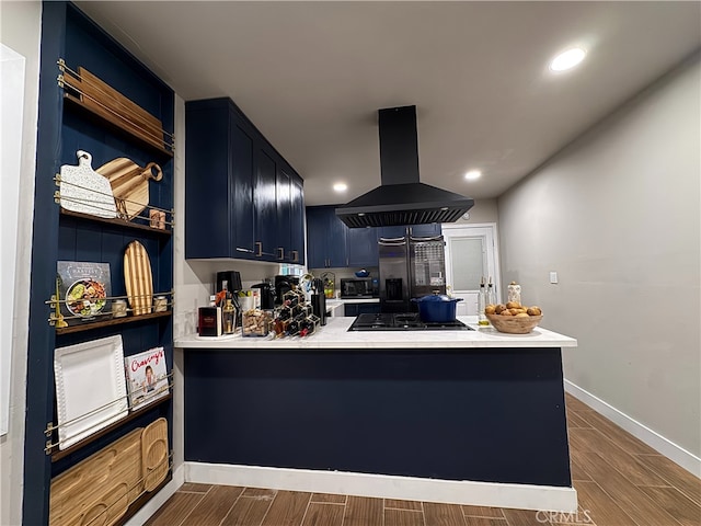 kitchen featuring black gas cooktop, kitchen peninsula, island exhaust hood, and blue cabinetry