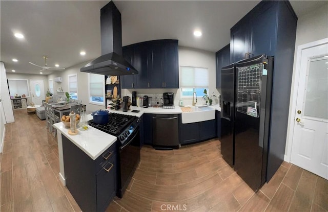 kitchen with black appliances, sink, island exhaust hood, and kitchen peninsula