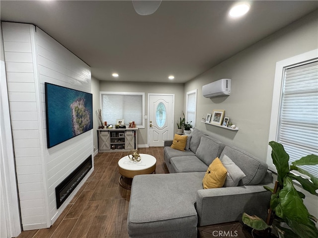 living room featuring a large fireplace and a wall mounted AC