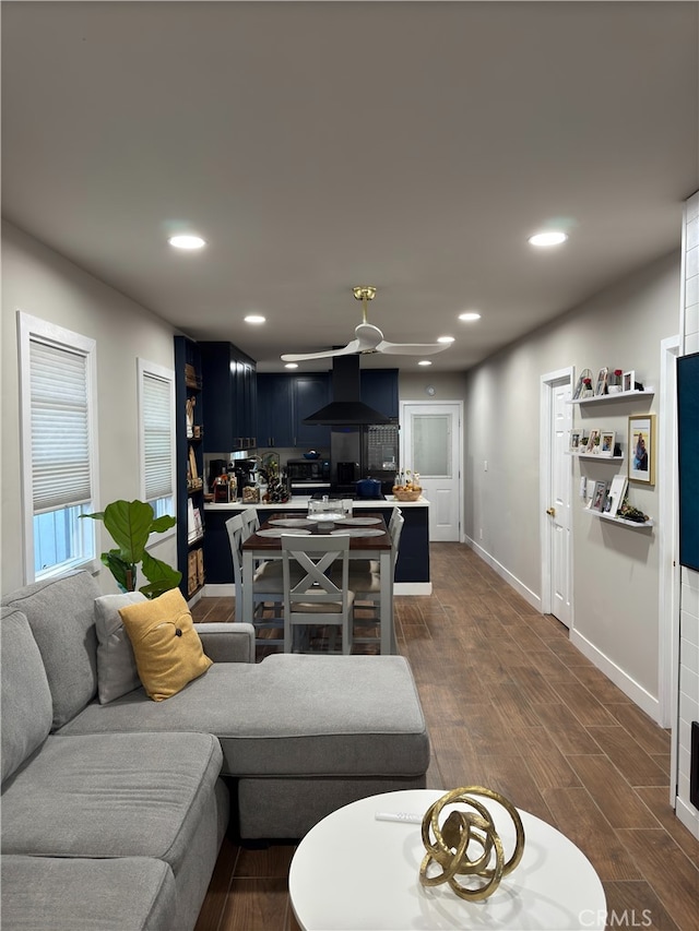 living room with ceiling fan and dark hardwood / wood-style floors