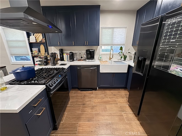 kitchen with dishwasher, wall chimney exhaust hood, sink, fridge with ice dispenser, and black range with gas stovetop