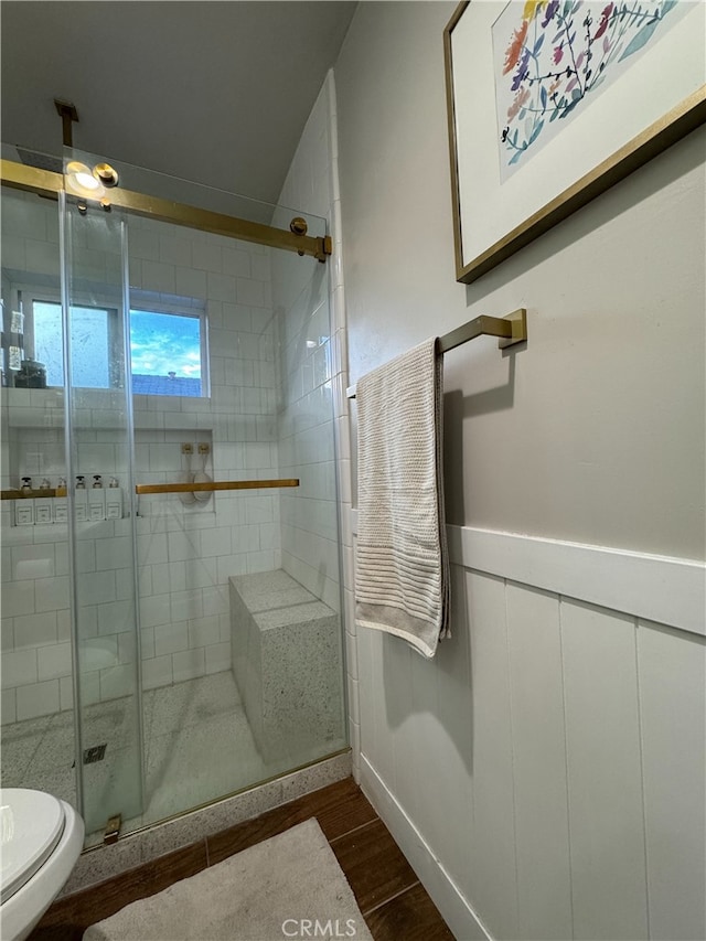 bathroom with walk in shower, wood-type flooring, and toilet