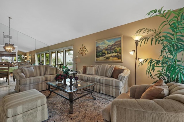 living room featuring an inviting chandelier and vaulted ceiling