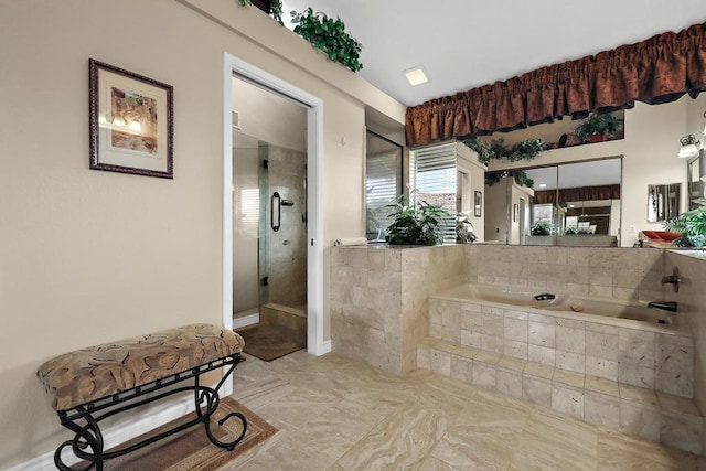 bathroom featuring a relaxing tiled tub