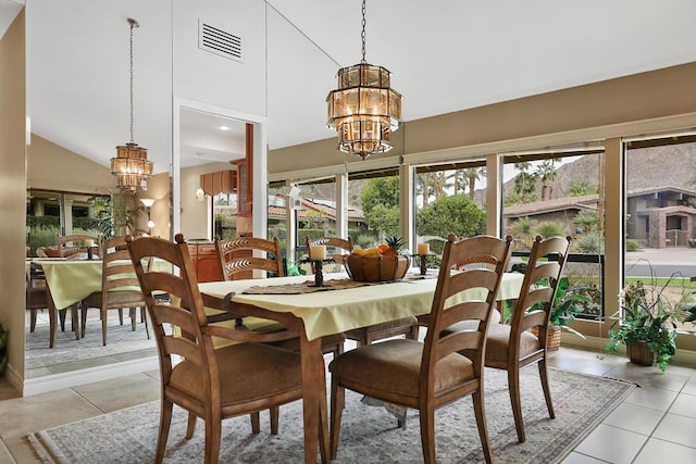 tiled dining room featuring a notable chandelier and high vaulted ceiling