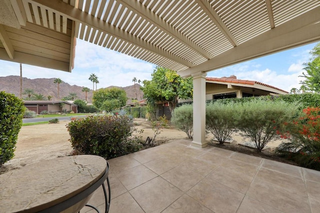 view of patio with a pergola and a mountain view