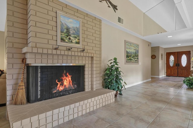 living room with high vaulted ceiling and a brick fireplace