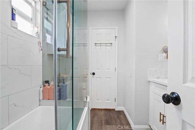 bathroom featuring shower / bath combination with glass door, vanity, and hardwood / wood-style flooring