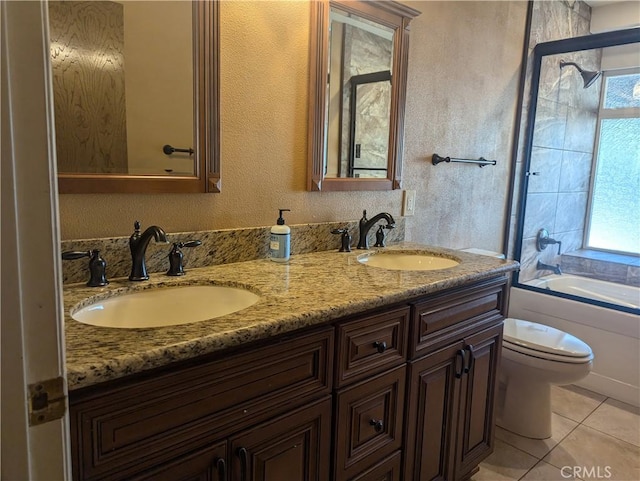 bathroom with toilet, tile patterned flooring, a healthy amount of sunlight, and vanity