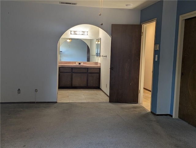 bathroom with ceiling fan, vanity, and tile patterned flooring