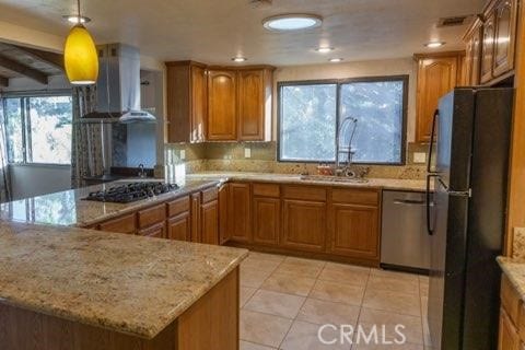 kitchen featuring exhaust hood, stainless steel dishwasher, gas stovetop, black refrigerator, and light tile patterned floors