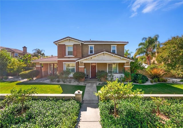 front of property featuring covered porch and a front lawn