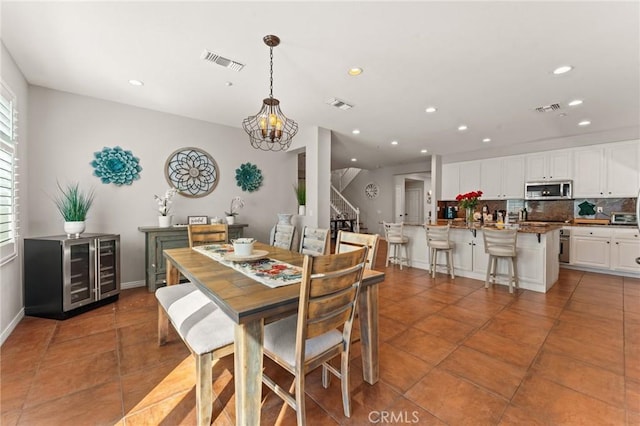 dining space with tile patterned floors and wine cooler