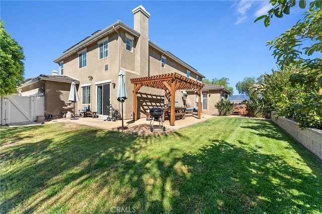 rear view of property featuring a pergola, a yard, and a patio