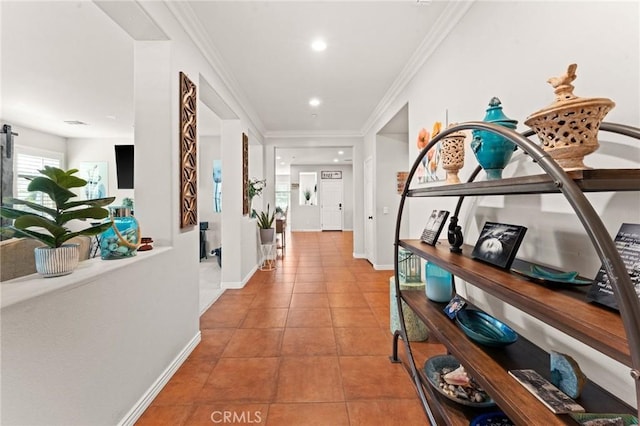 hall featuring light tile patterned floors and ornamental molding