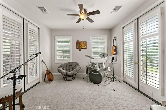 playroom with light carpet and ceiling fan