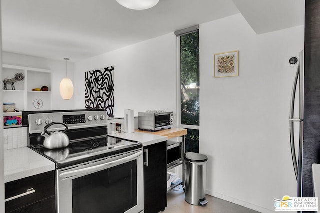 kitchen featuring hanging light fixtures and stainless steel electric range oven