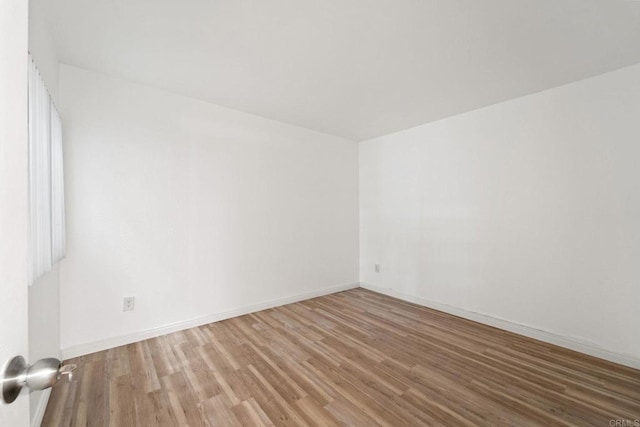 spare room featuring hardwood / wood-style floors