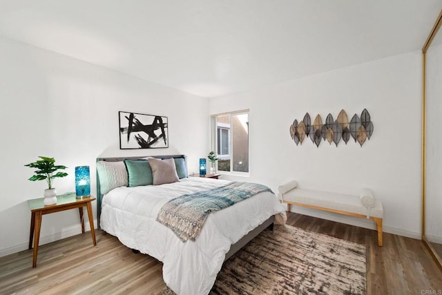 bedroom with wood-type flooring