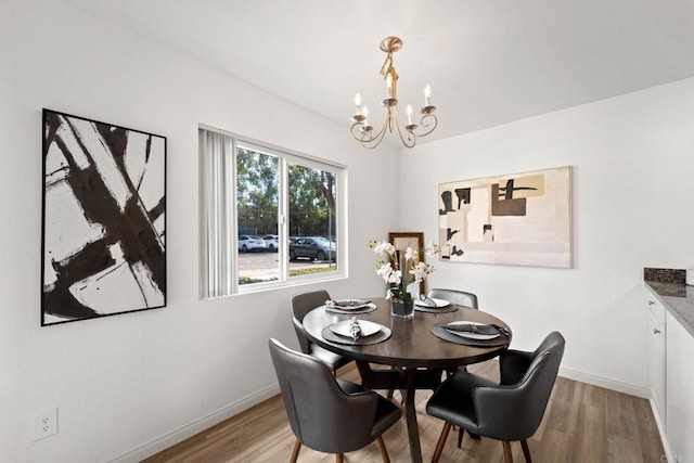 dining room featuring a notable chandelier and light hardwood / wood-style flooring