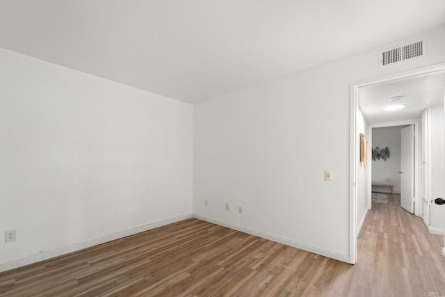 spare room featuring light hardwood / wood-style floors