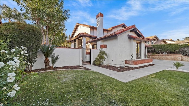 view of side of home featuring a lawn