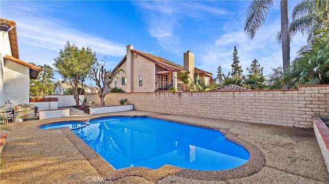 view of pool with an in ground hot tub